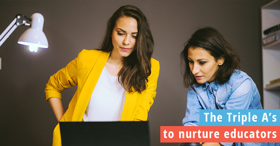 Two women working together with a laptop in an office