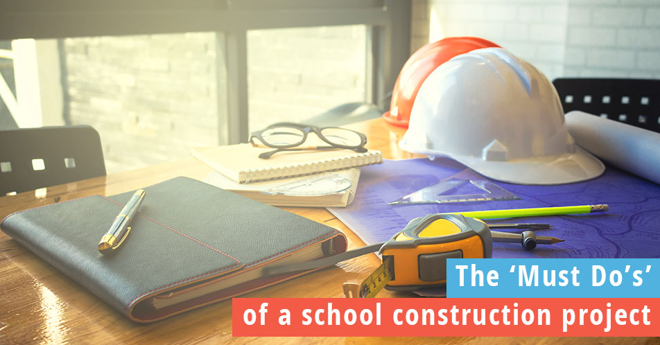 Photo of hard hats and notebooks on a construction project