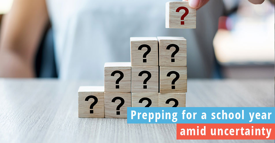 Woman placing blocks with question marks to represent uncertainty